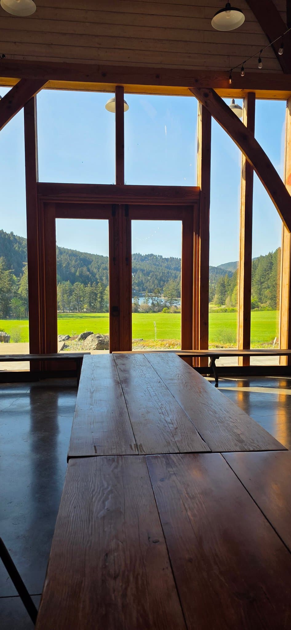 Looking out through the glass gable wall to the fields and cove